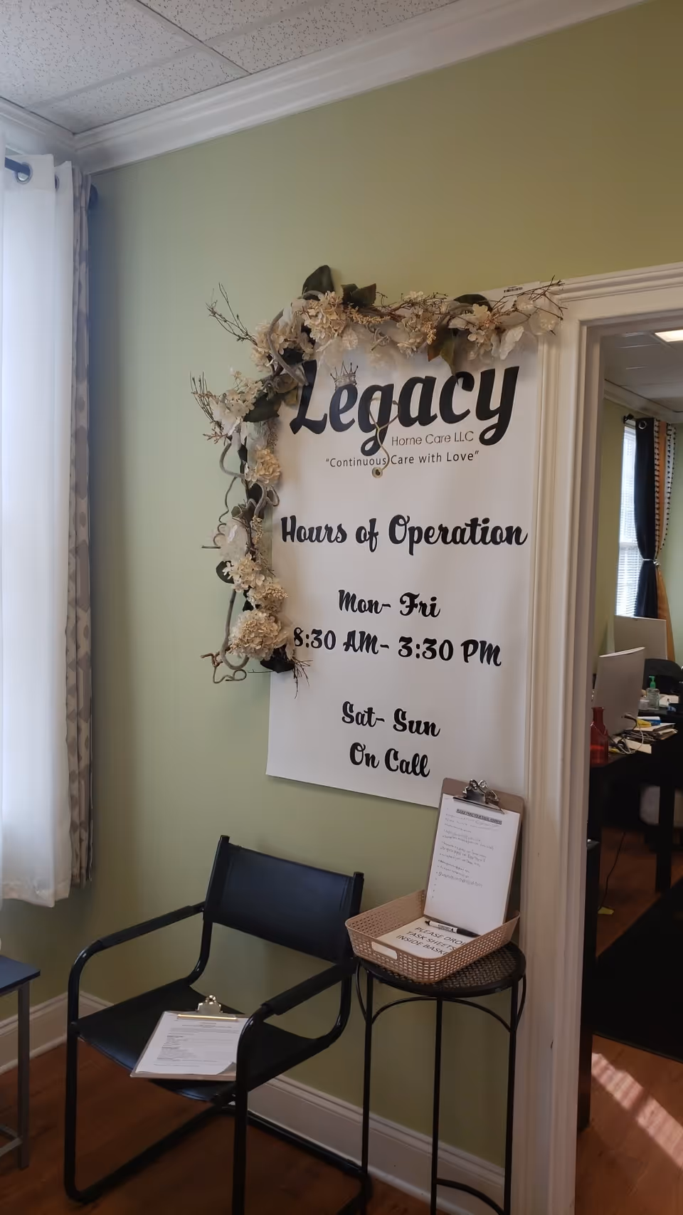 Interior reception area featuring a Legacy Home Care LLC sign and seating.