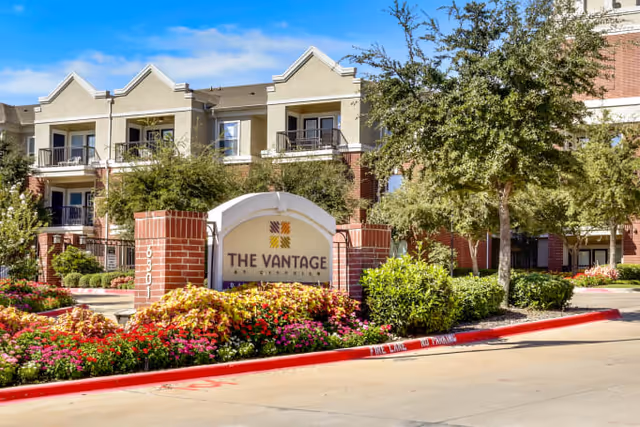 The Vantage at Cityview exterior entrance with landscaped sign and building.