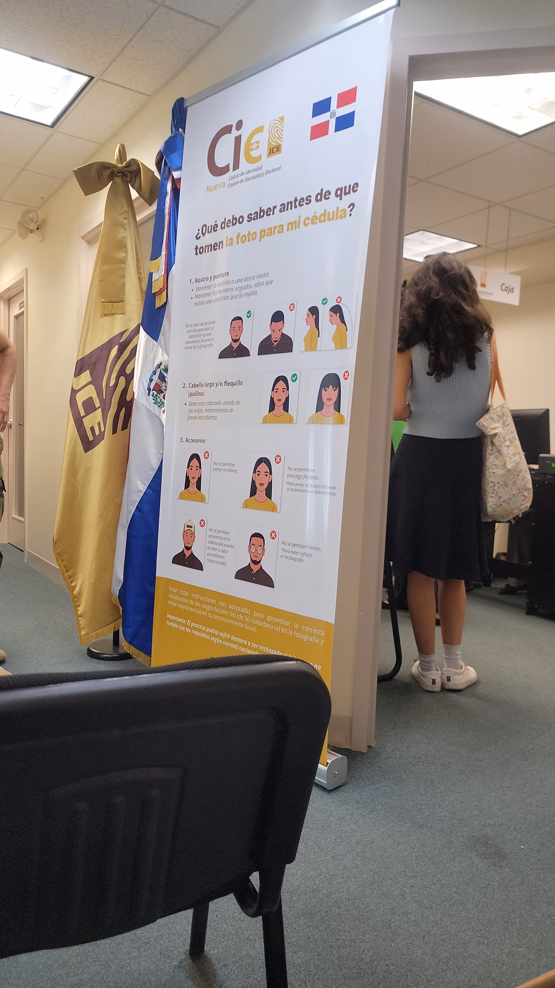 Indoor scene at Guardian Healthcare with a large informational poster and a person standing nearby