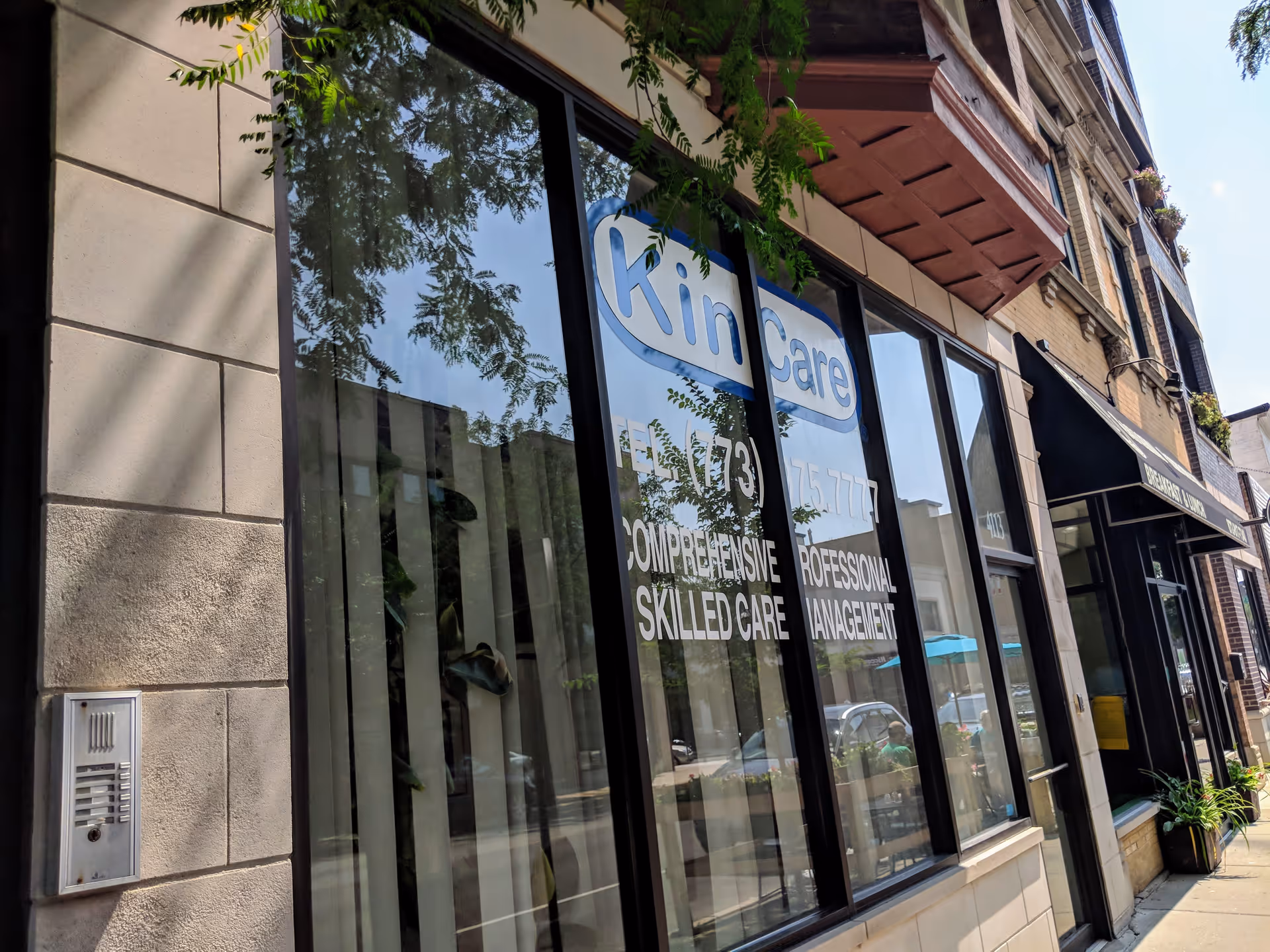 Exterior of a Kin Care Inc building with large glass storefront windows and signage.