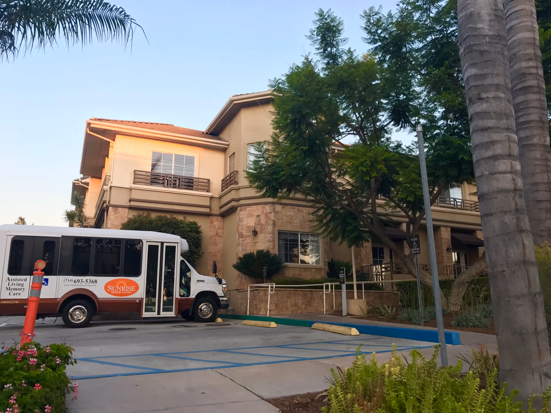 Sunrise of Yorba Linda exterior building with a parked shuttle bus in front.
