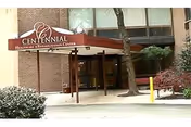 Entrance of Centennial Healthcare and Rehabilitation Center with red canopy and glass doors.