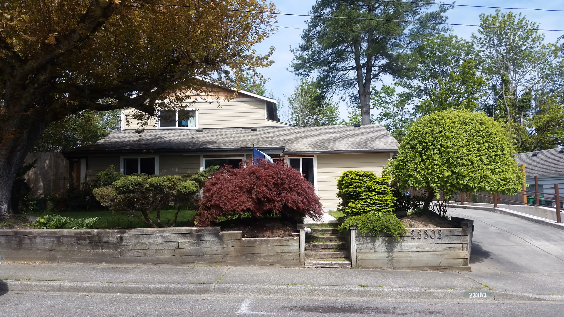 Front exterior of Mountlake Terrace AFH, a single-story home with landscaped front yard.