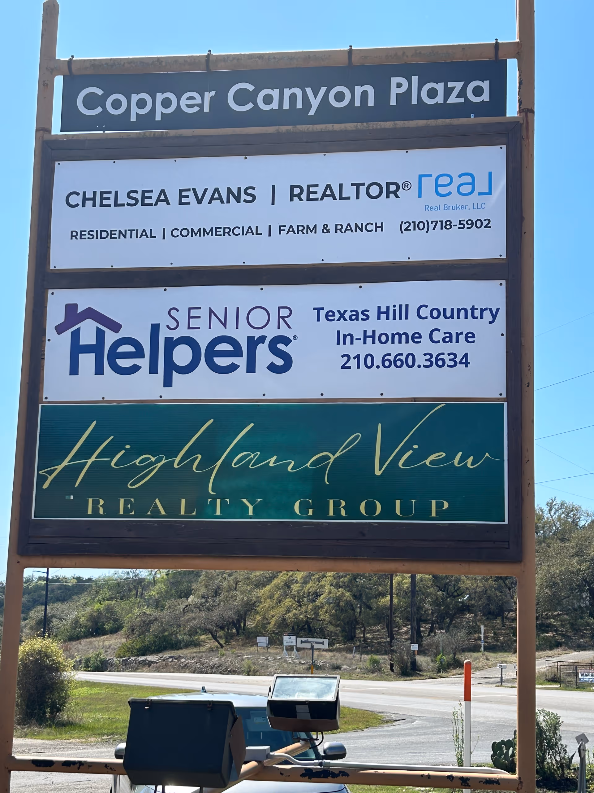 Outdoor signboard showing Copper Canyon Plaza and Senior Helpers-Texas Hill Country signs.