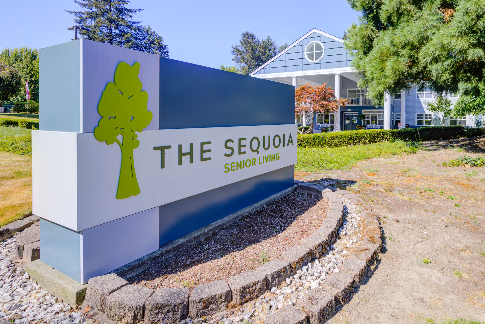 Exterior view of The Sequoia Senior Living sign with the building in the background.