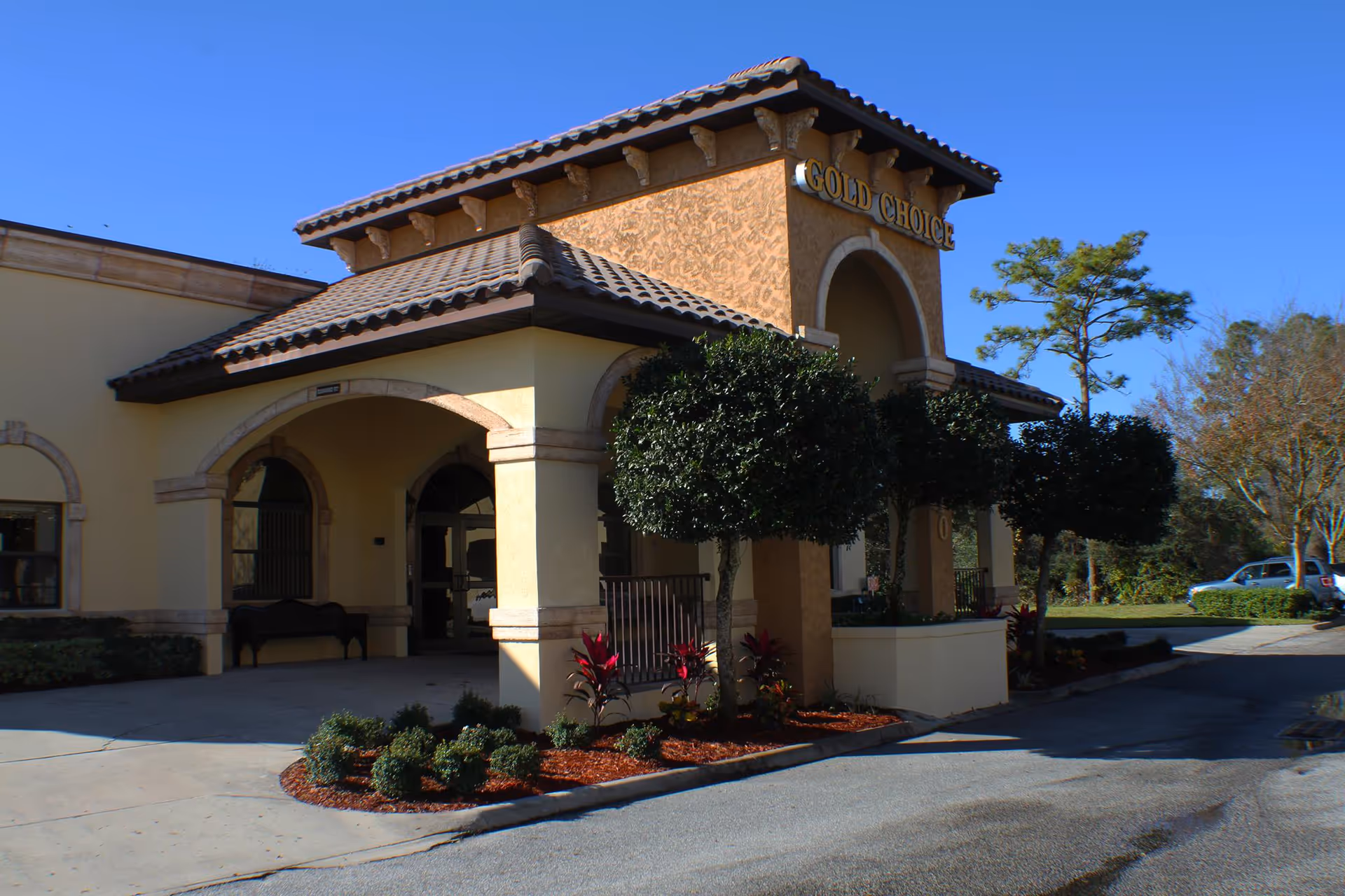 Exterior view of Gold Choice Ormond Beach Assisted Living entrance with landscaping