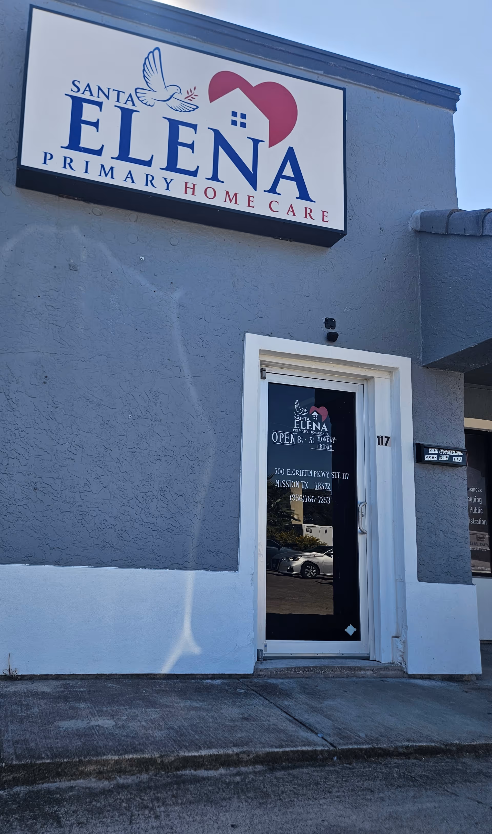 Exterior view of Santa Elena Primary Home Care building with entrance door and sign.