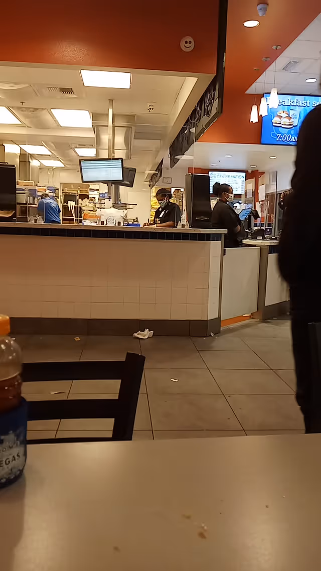 Interior dining area at SHARE Village Las Vegas 3 with service counter and staff.