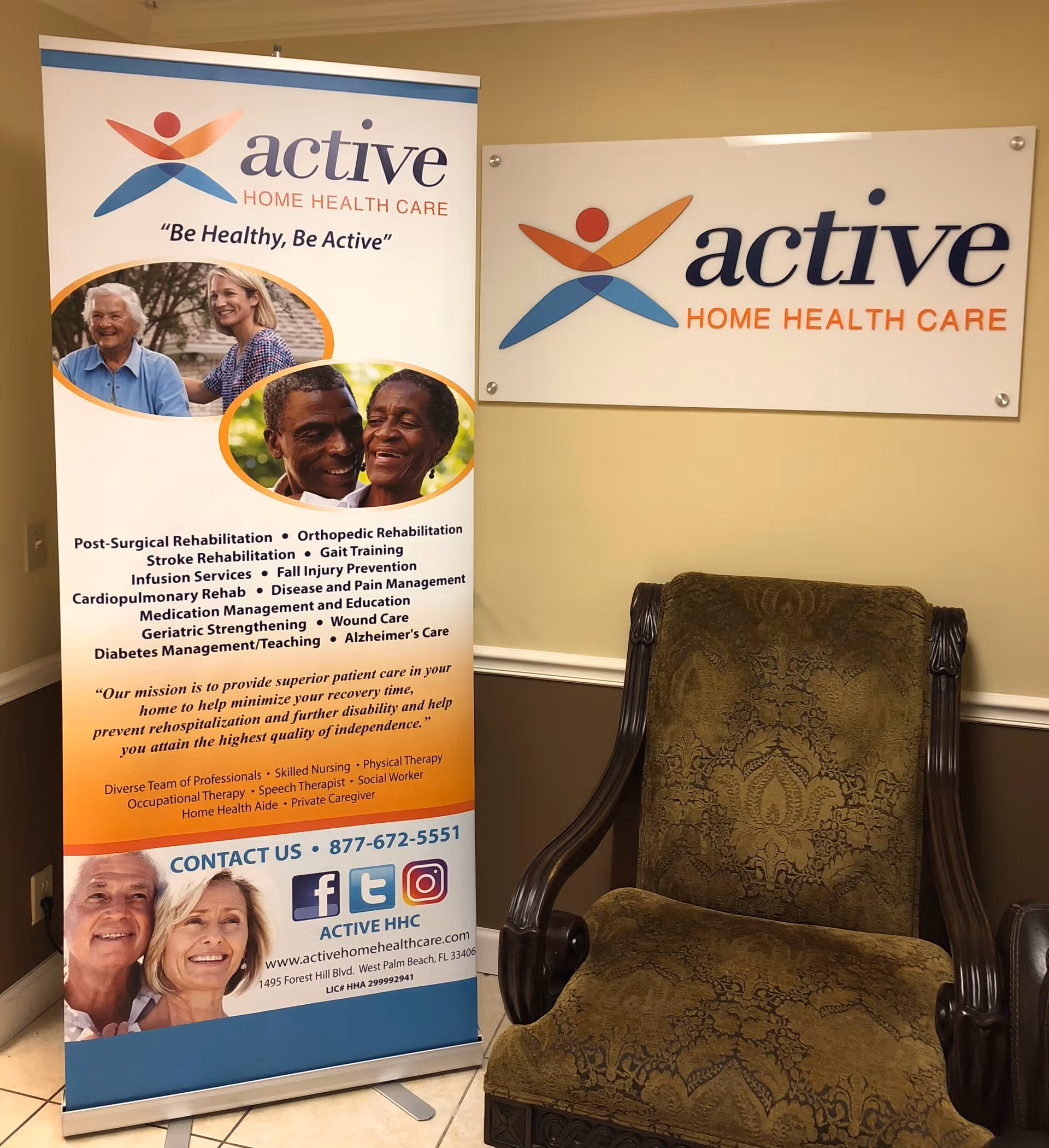 Indoor lobby featuring two Active Home Health Care banners and a patterned armchair.