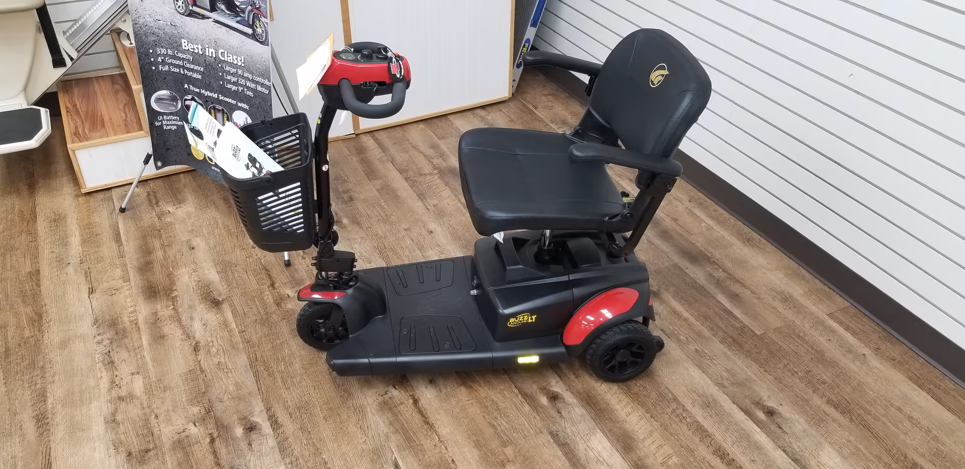 Mobility scooter on a wooden showroom floor inside a medical supply store.