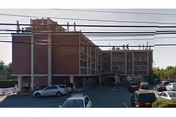 Exterior view of Central Island Healthcare building with a parking lot in front