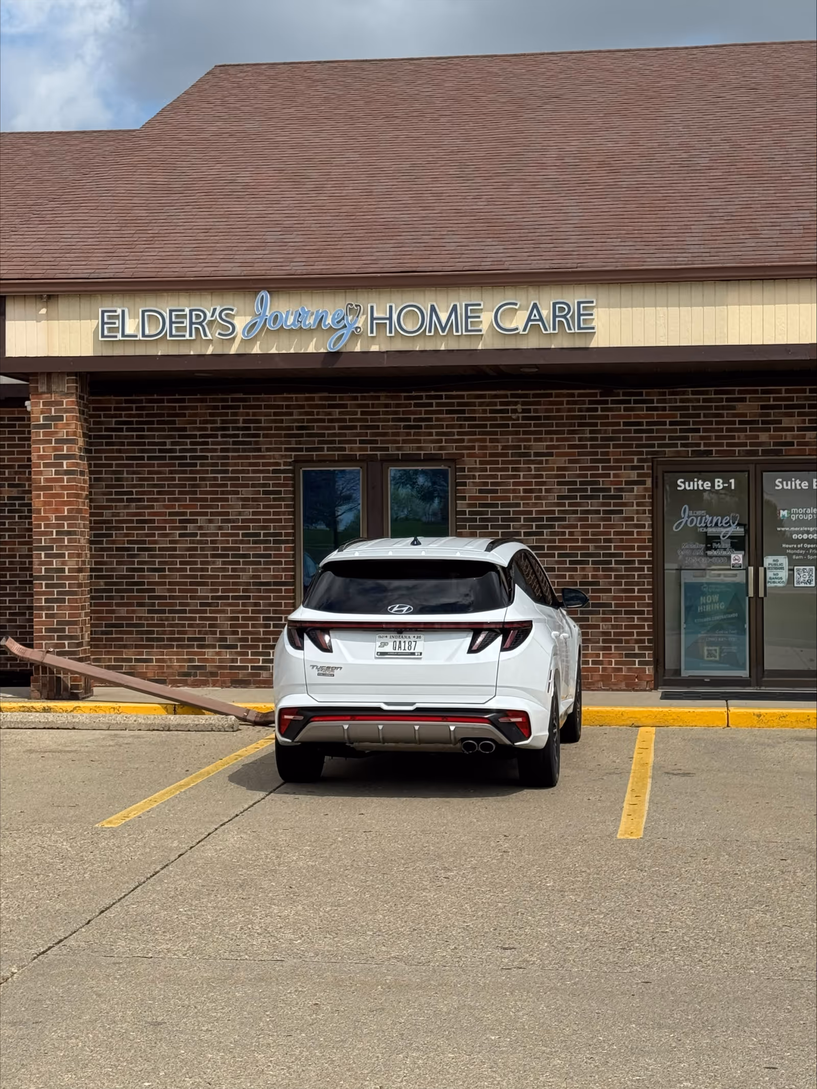 Front view of Elder's Journey Home Care building with a white SUV parked in front.