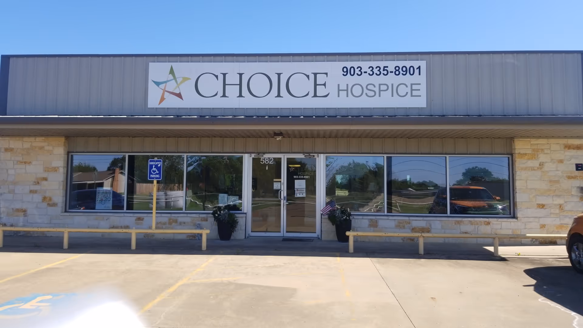 Front exterior of Choice Hospice with sign, glass doors, and surrounding parking.