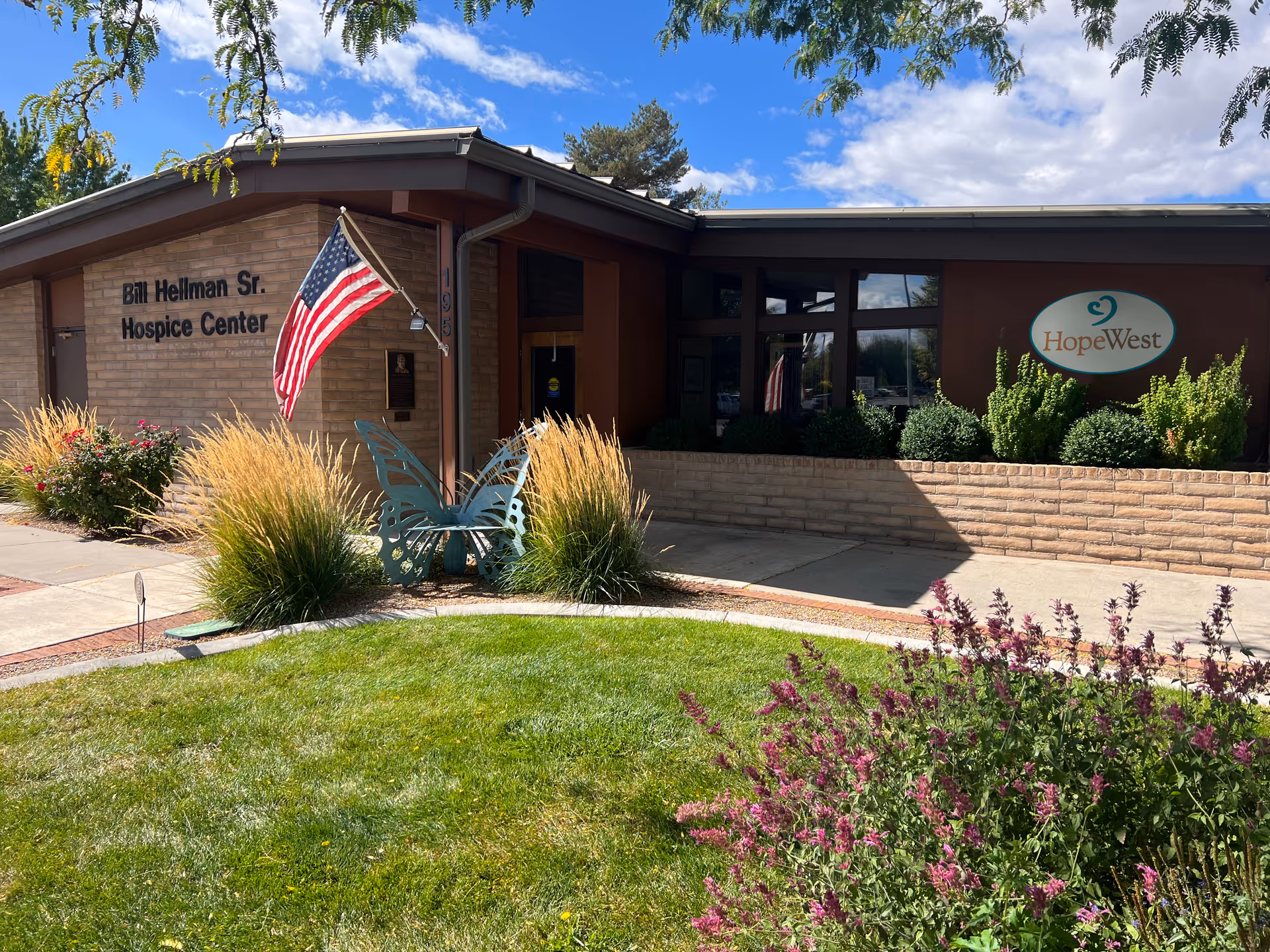 Exterior view of HopeWest Administrative Offices with sign and landscaping.