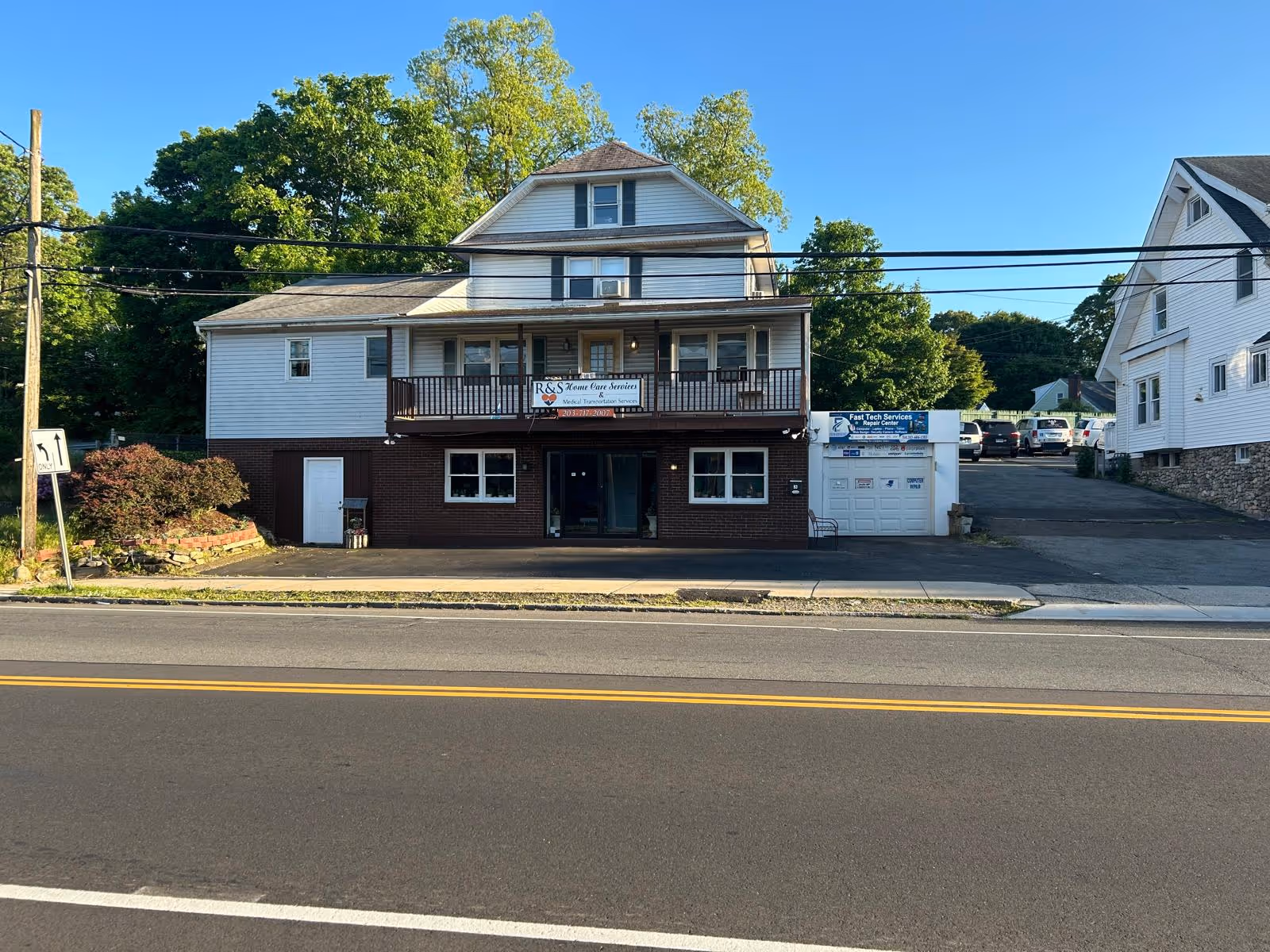 Exterior of a two-story building with a front balcony and R&S Home Care Services sign.