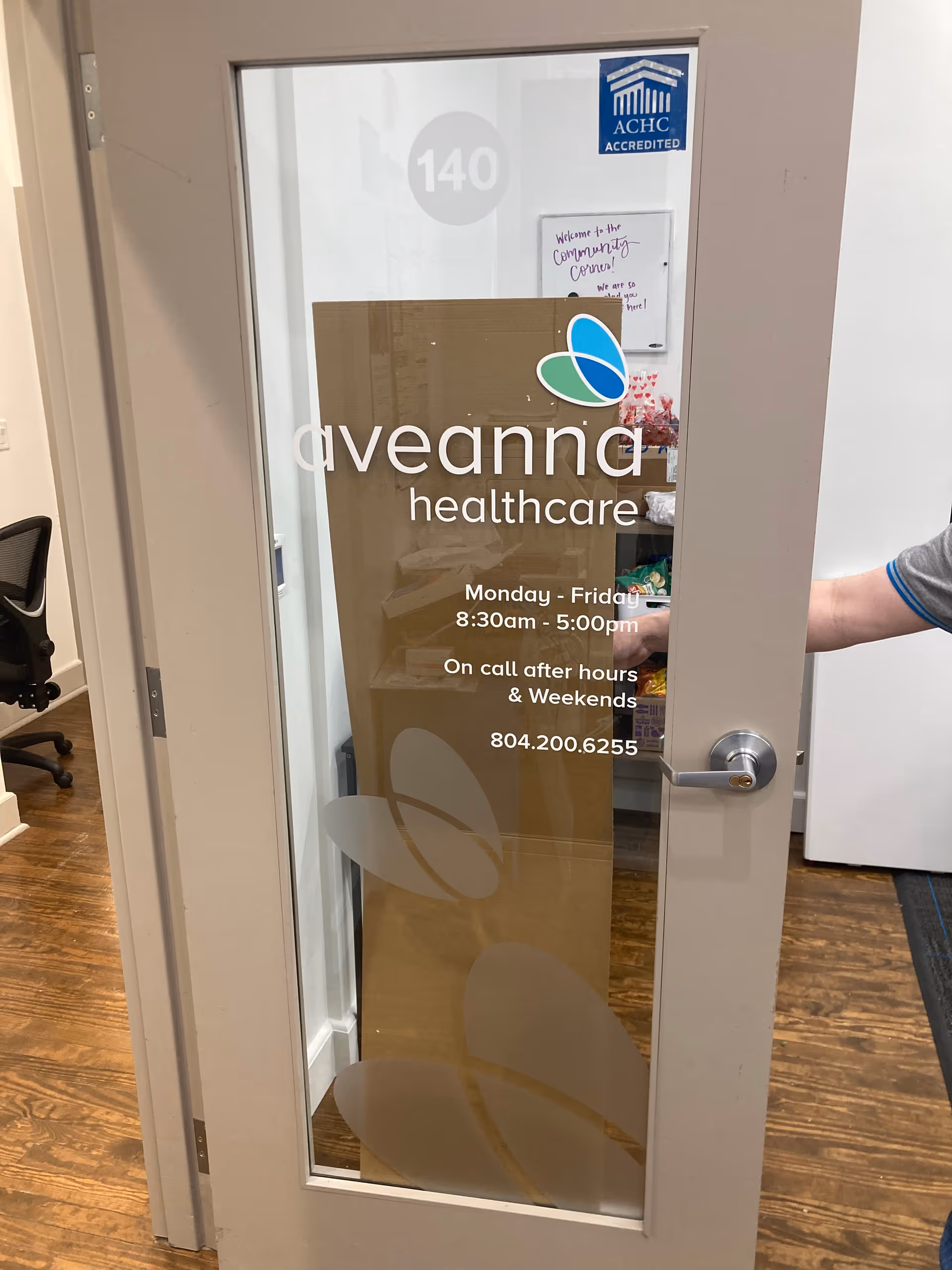 Glass door labeled Aveanna Healthcare with an interior office area visible through the glass.