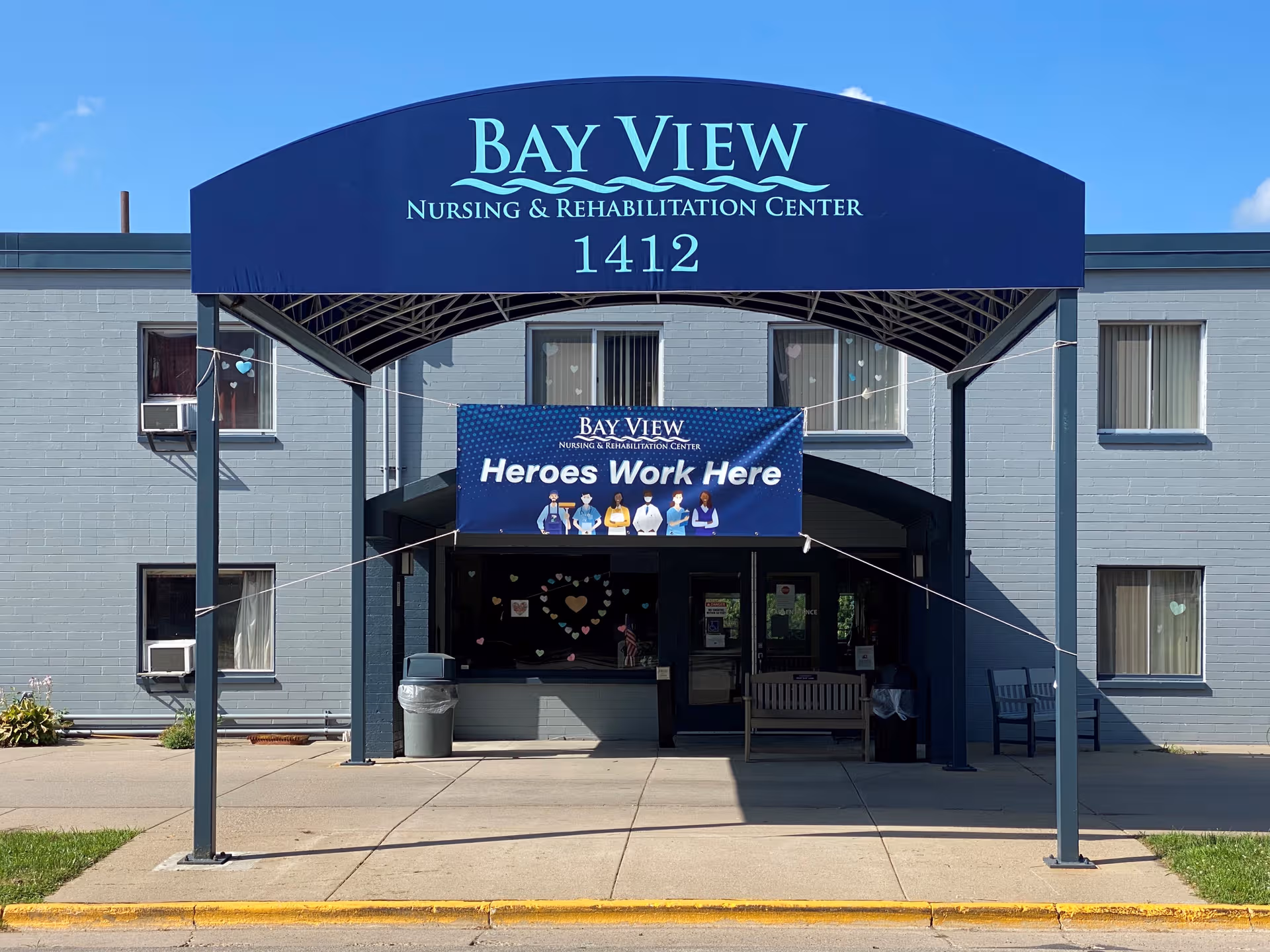 Blue Bay View Nursing & Rehabilitation Center building front with banner and entrance.