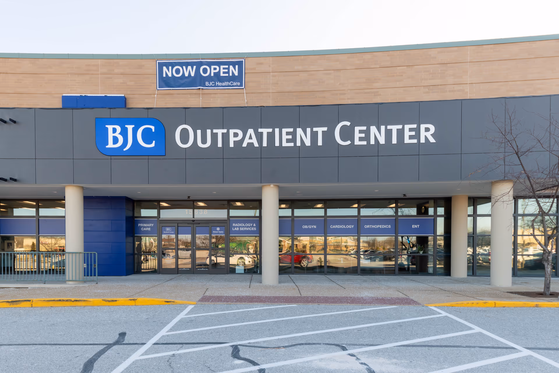 Exterior view of BJC Outpatient Center Chesterfield with glass doors and a Now Open banner