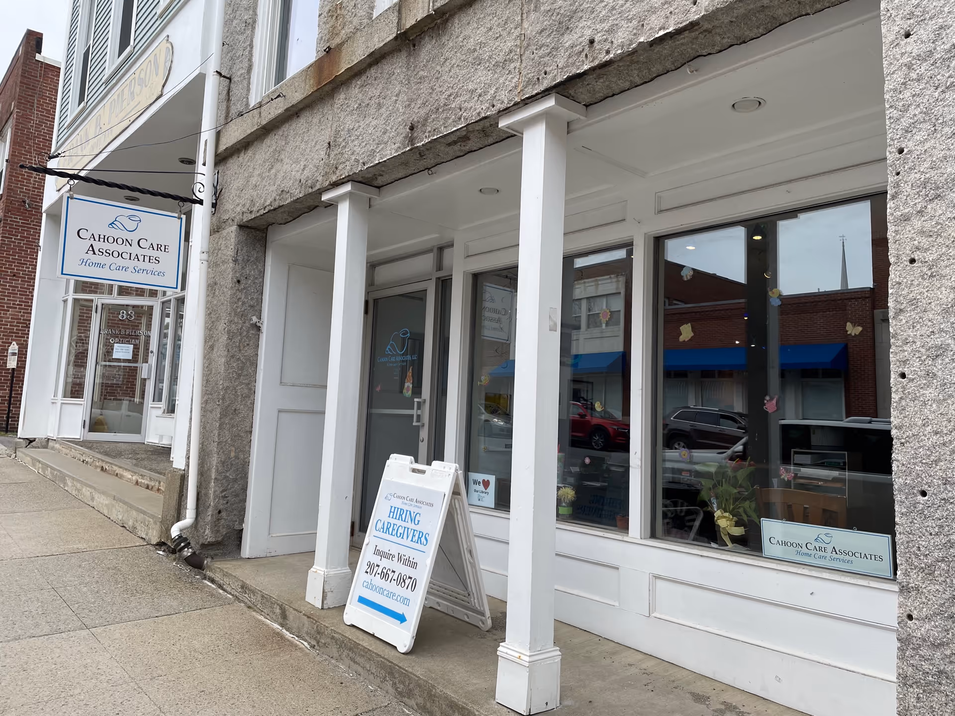 Storefront of Cahoon Care Associates with signs, windows, and a sidewalk sandwich board.