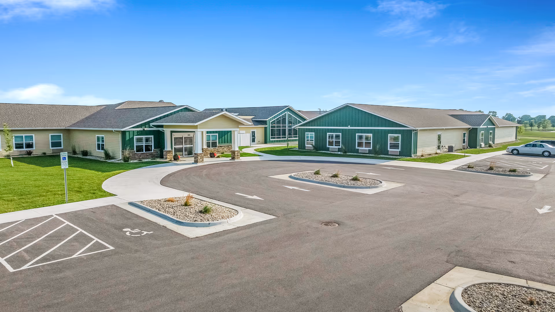 Exterior view of Peaceful Pines Senior Living at Madison with parking and entryway