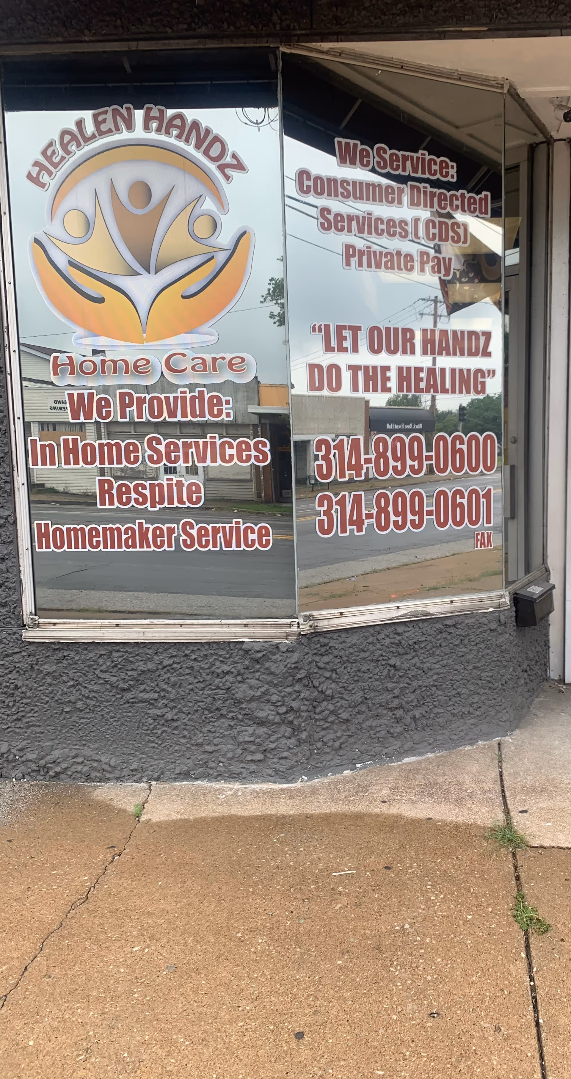 Storefront window advertising Healen Handz Home Care LLC with services and phone numbers