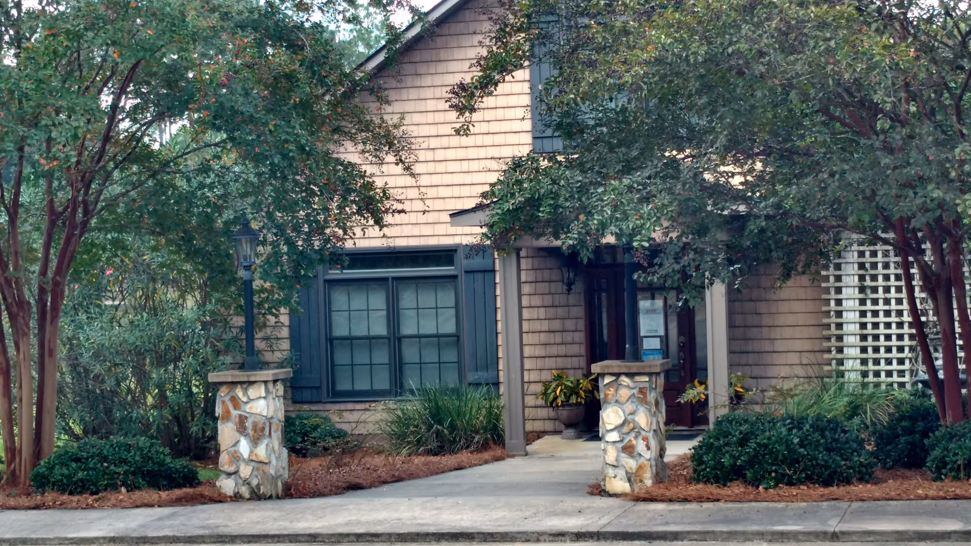 Exterior view of Community Home Nursing Services building with a stone entrance and landscaping.