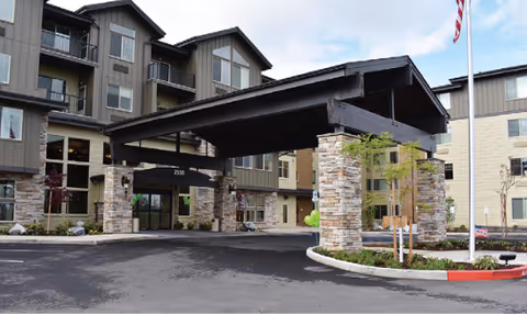 Exterior view of Bonaventure of Medford entrance with a covered porte-cochere and stone columns.