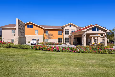Exterior view of Meridian Meadows Assisted Living facility with manicured lawn and entrance.