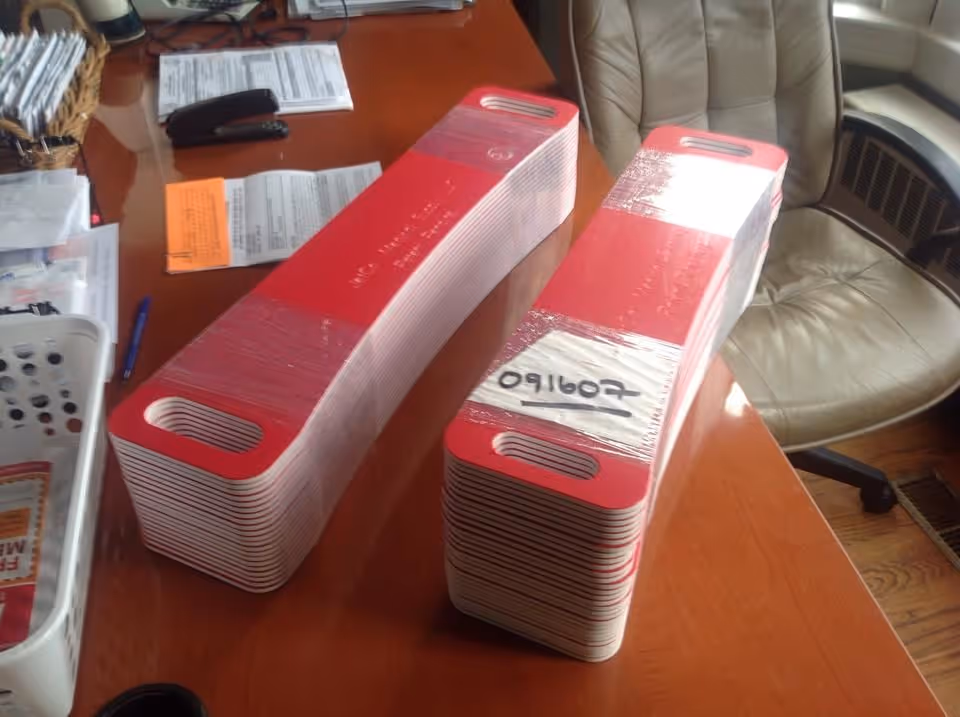 Stacks of red and white card organizers on a wooden desk in an office