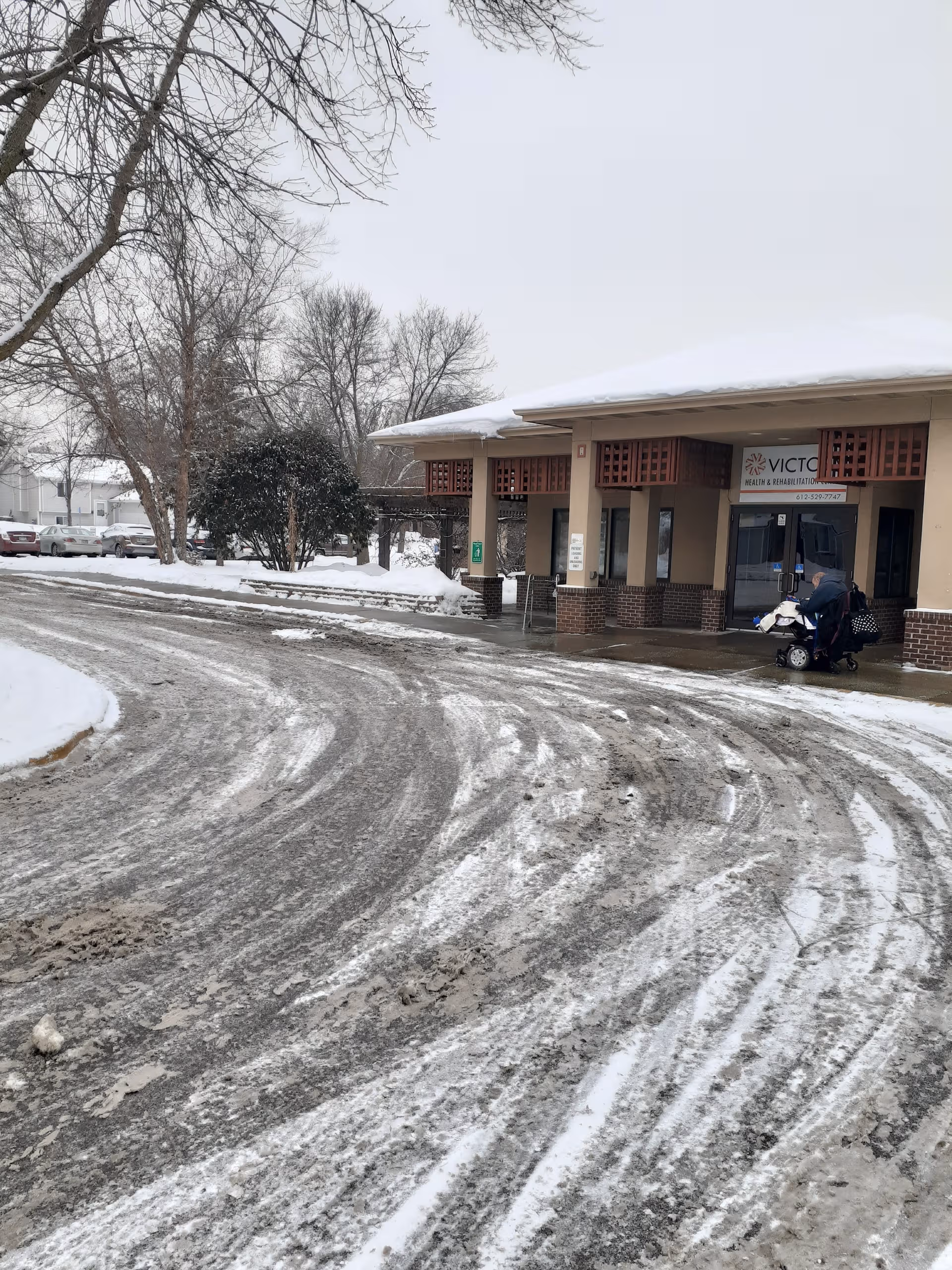 Snowy driveway and front entrance of Victory Health and Rehabilitation Center.