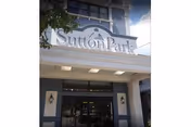 Facade of Sutton Park Center for Nursing and Rehabilitation showing the entrance and sign.