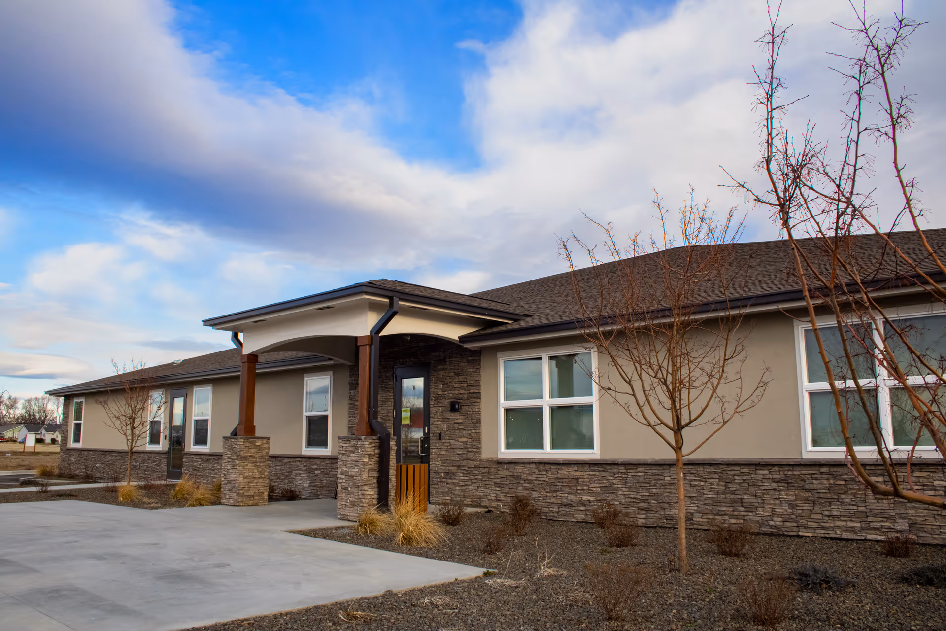 Sunset Villa Memory Care exterior with a front entrance and stone accents.