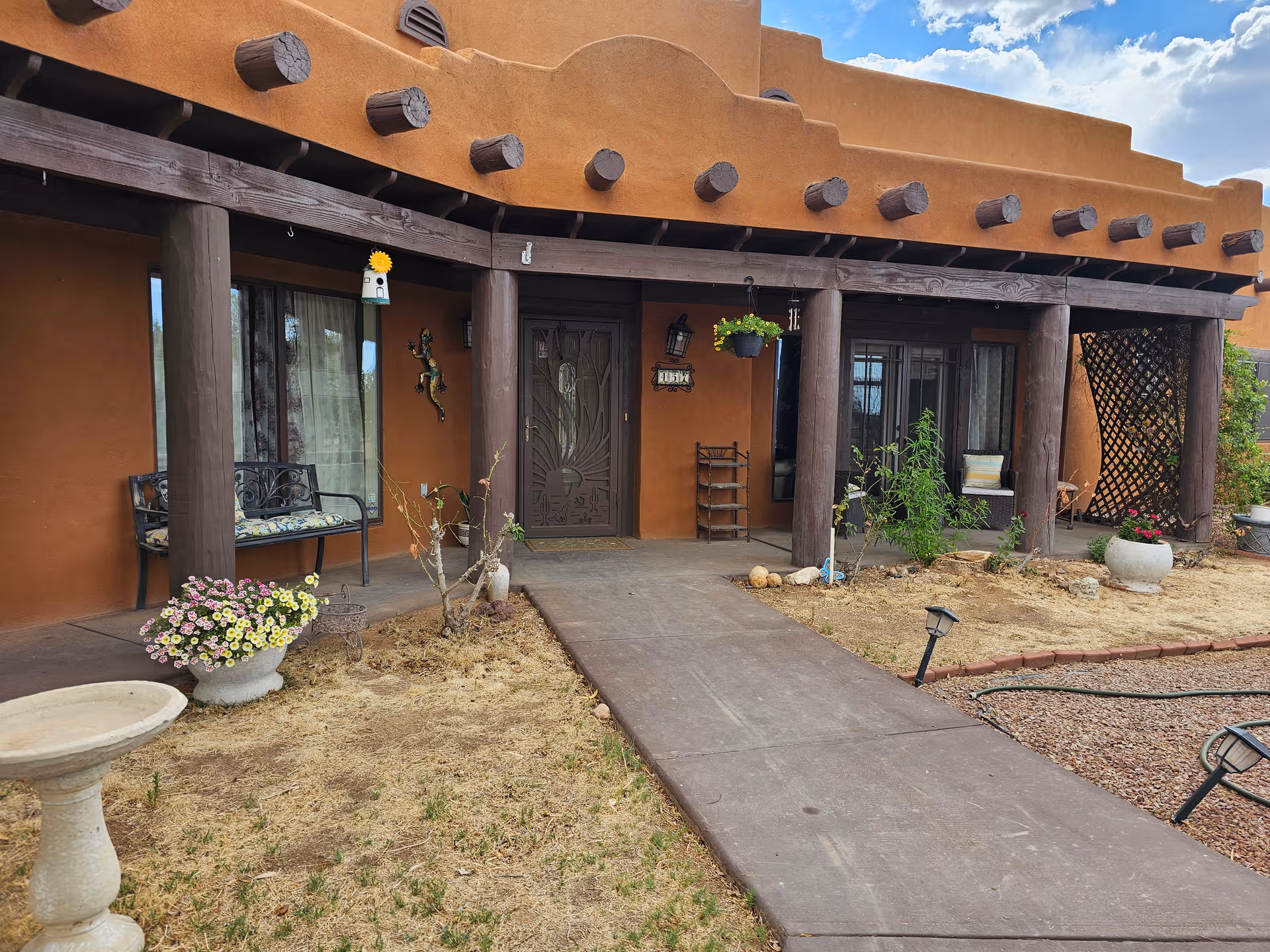 Casa De Angeles Assisted Living Inc front entrance with adobe-style porch and garden.