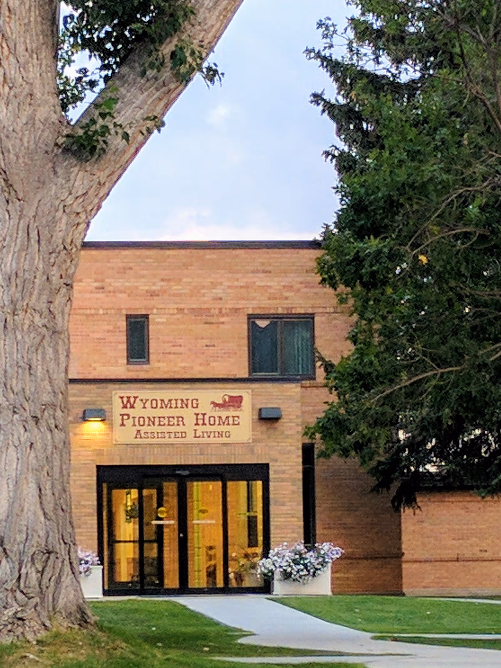 Front view of Wyoming Pioneer Home Assisted Living entrance with glass doors.