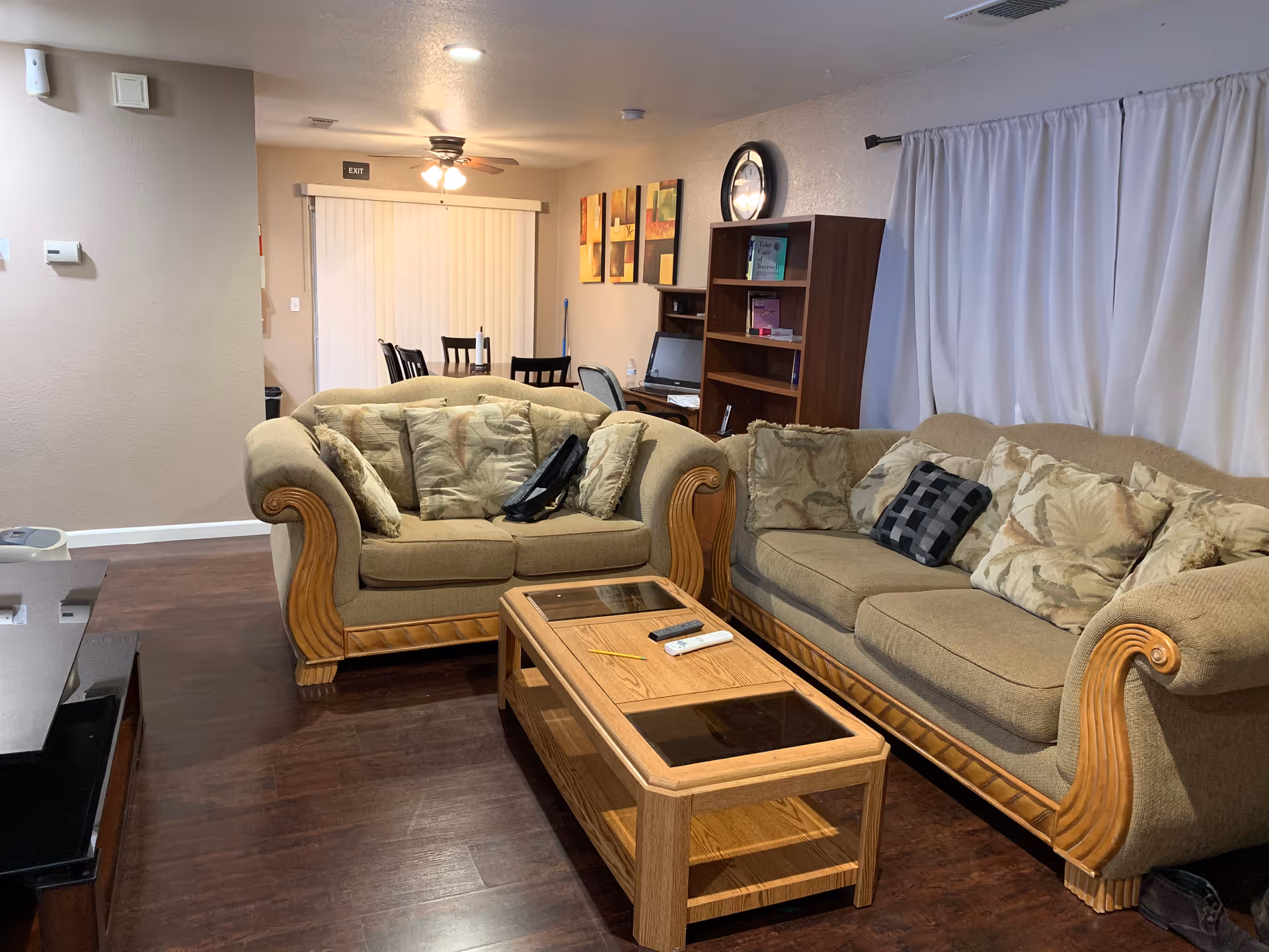 Two beige upholstered sofas arranged around a wooden coffee table in a cozy living room.