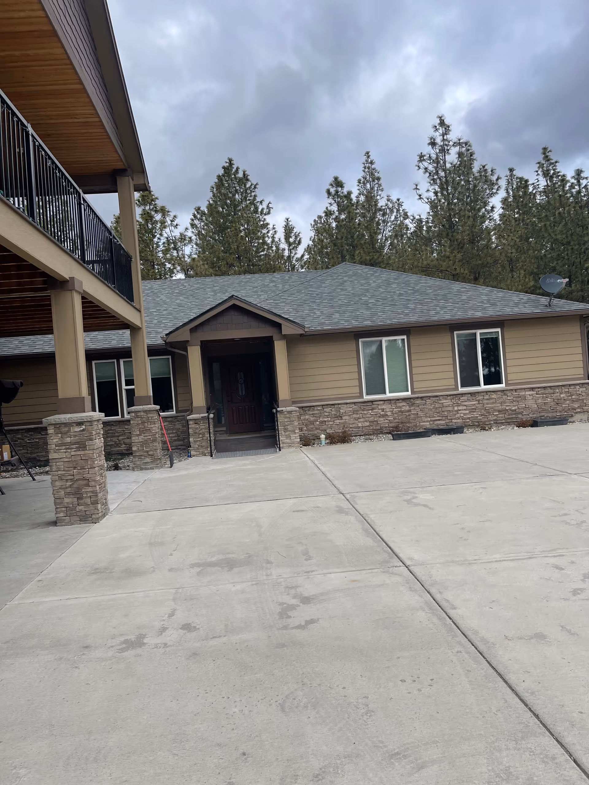 Front view of Harmony Lifecare Adult Family Home exterior with entrance and paved driveway.