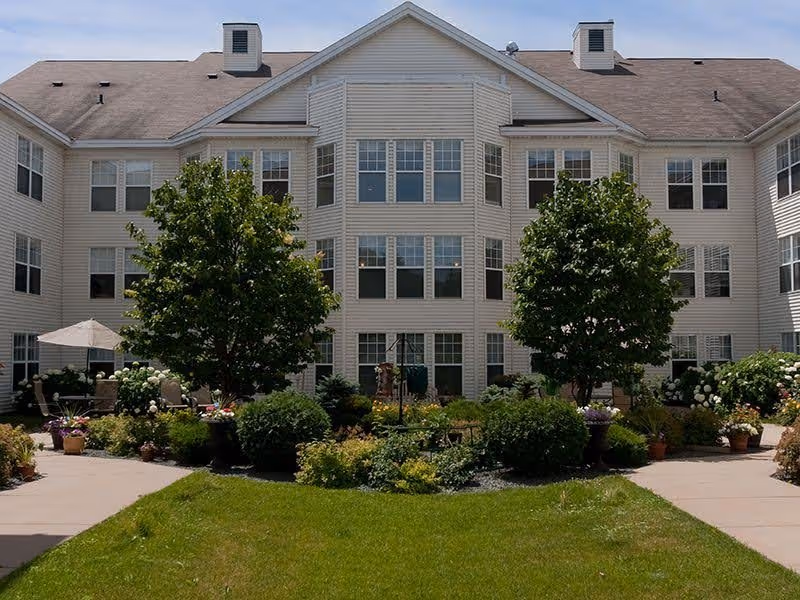 Exterior view of Meridian Manor senior living building with landscaped front garden.