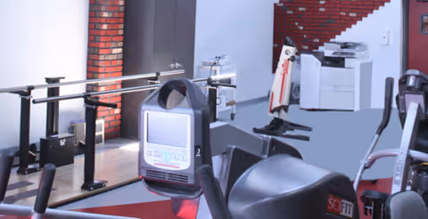 Indoor fitness room with exercise bikes and gym equipment.
