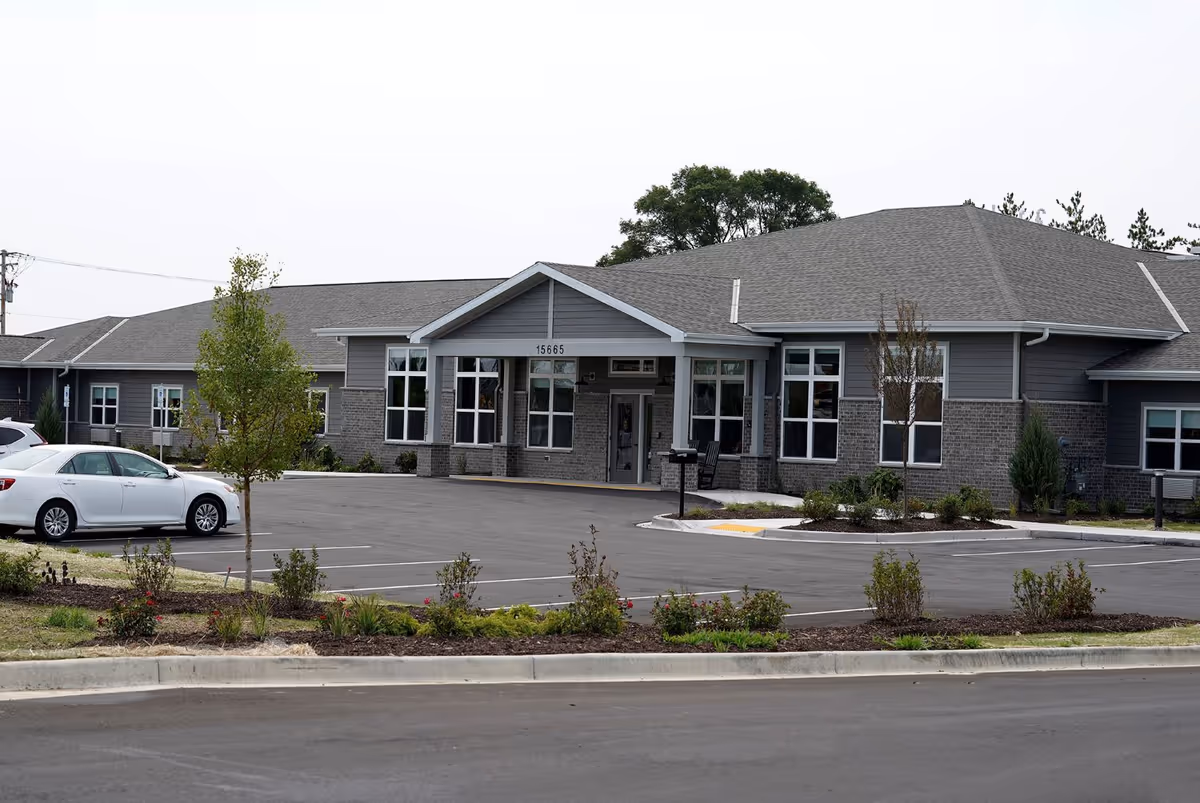Front exterior of Anita's Gardens of Brookfield senior living facility with parking lot.