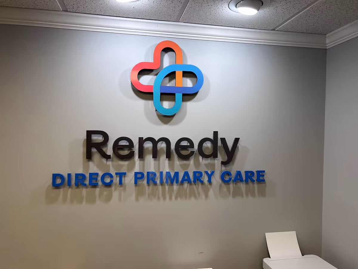 Indoor wall with a colorful medical logo and Remedy Direct Primary Care sign.