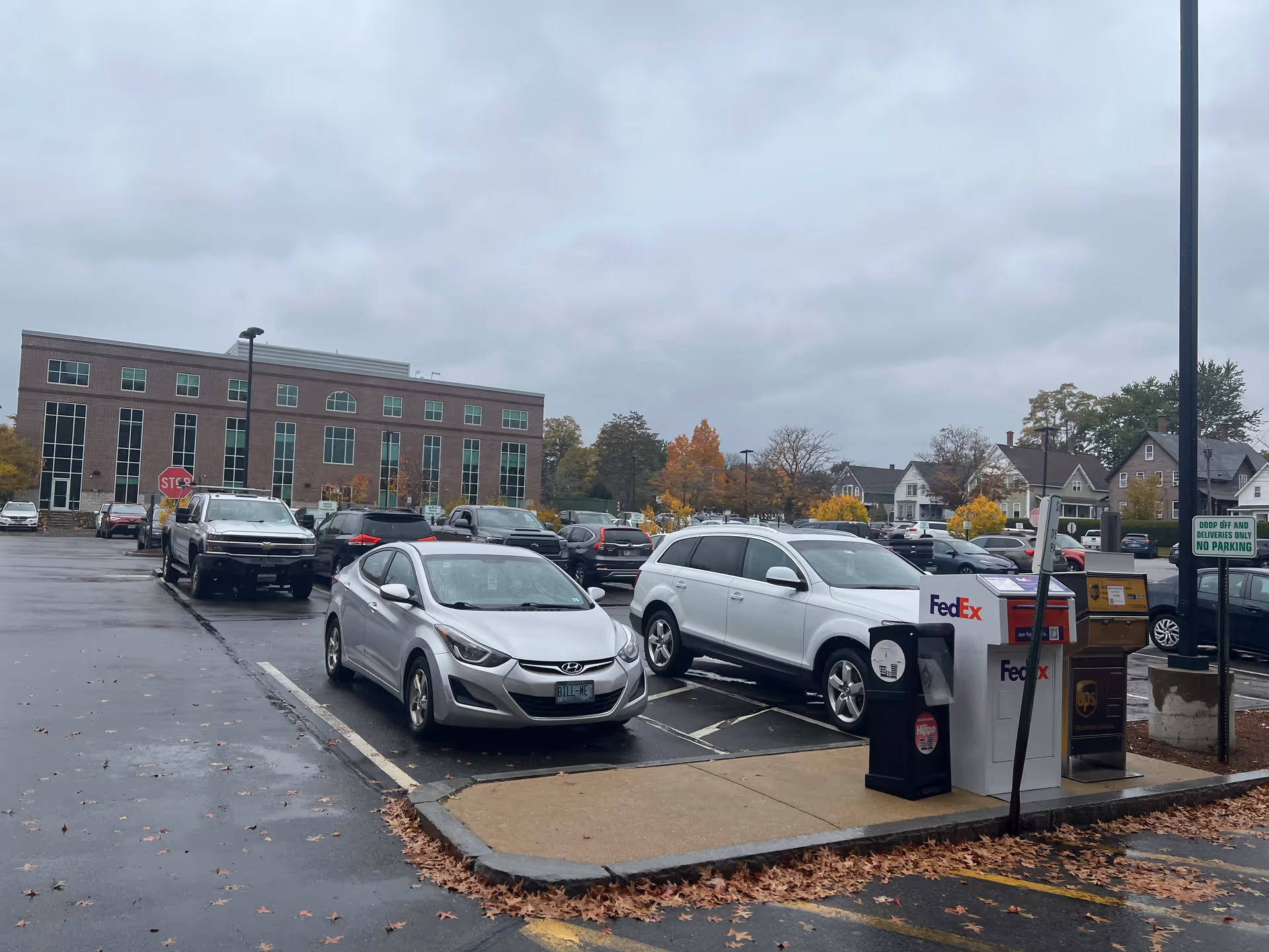 Exterior view of Granite VNA facility with a parking lot and cars.