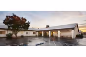 Exterior view of River Valley Care Center with a covered entrance and parking lot.