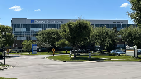 Exterior of Norton Healthcare Medical Plaza I Brownsboro with trees and parking.