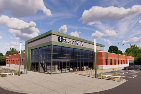 Front exterior of Akron Children's Health Center Amherst, featuring a glass entrance and adjacent parking.