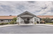 Front view of Regency at Northpointe entrance with a curved driveway and landscaped surroundings.