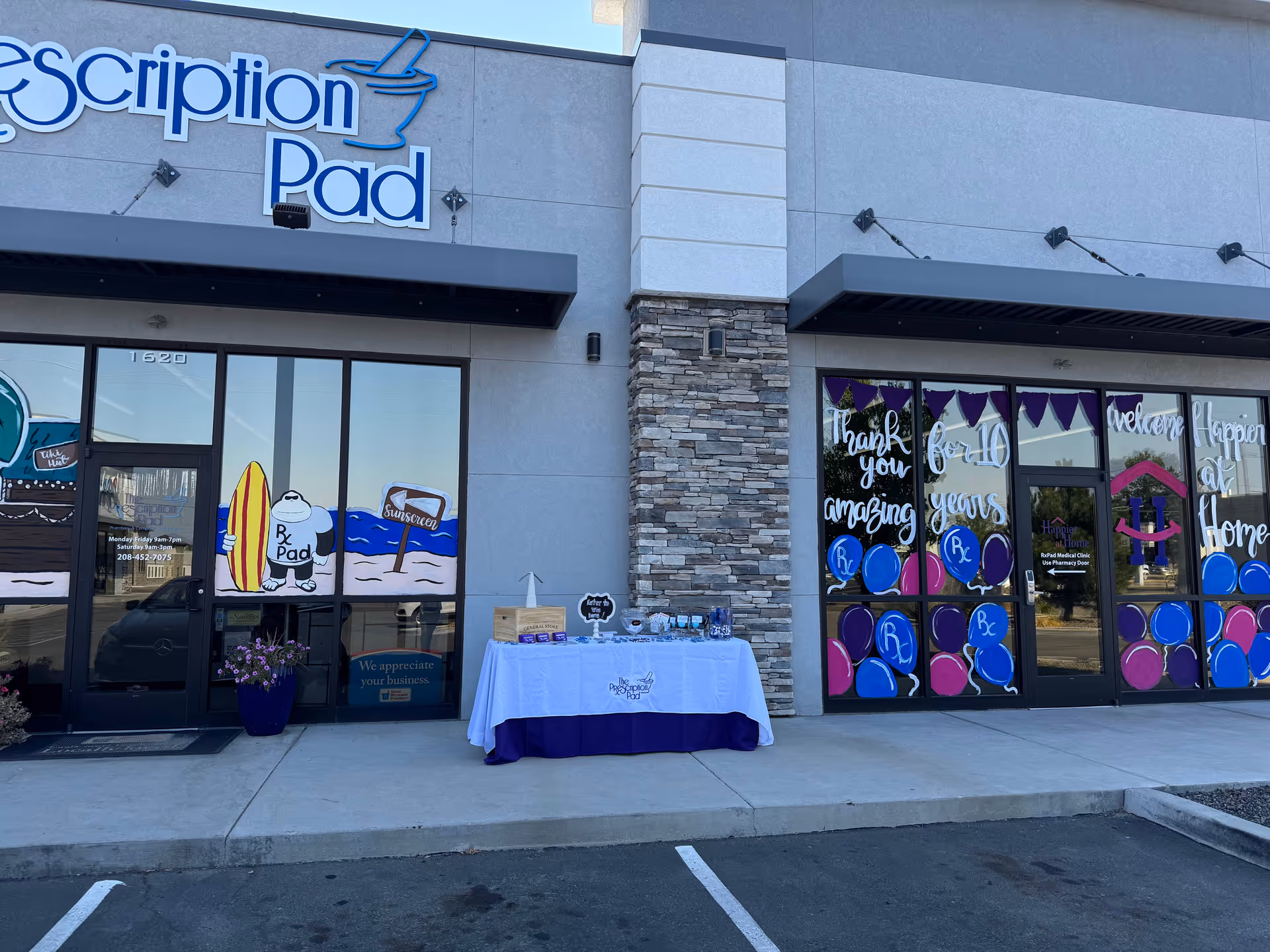Exterior of Happier At Home Southwest facility with festive window decorations and a front table.