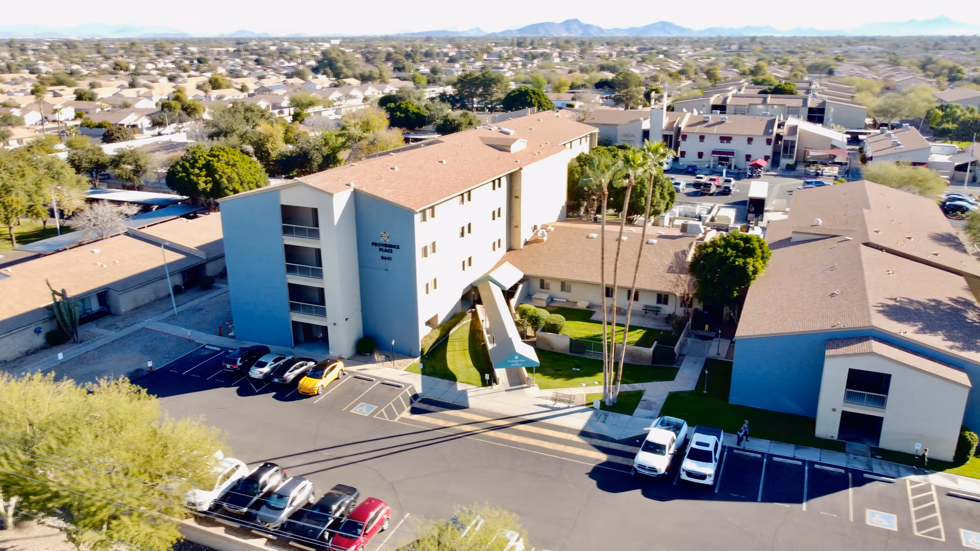 Aerial view of Providence Place at Glencroft campus with parking and palms.
