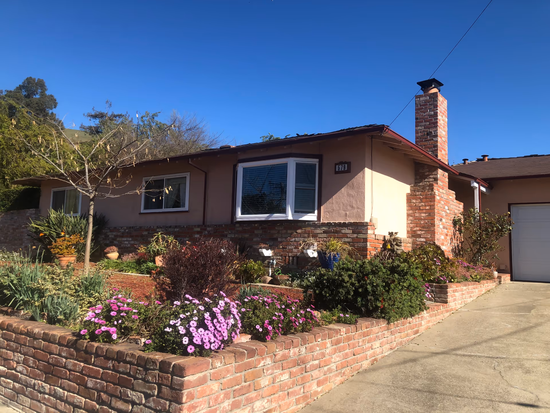 Single-story residence with brick facade, landscaped front yard, and driveway.