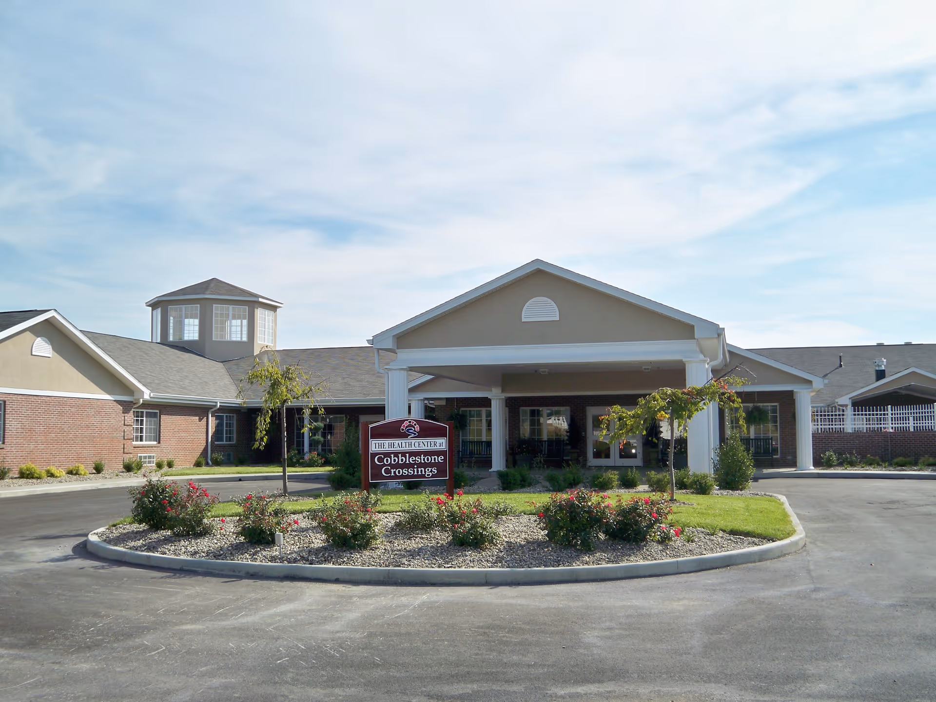 Front view of Cobblestone Crossings Health Campus with circular driveway and landscaped entry.