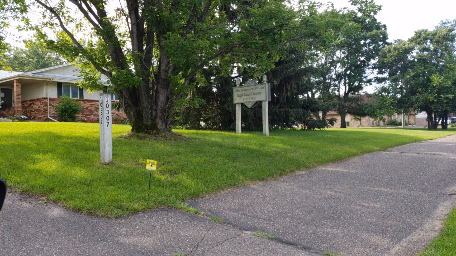 Front exterior of Life's Companion PCA facility with sign, lawn, and driveway.